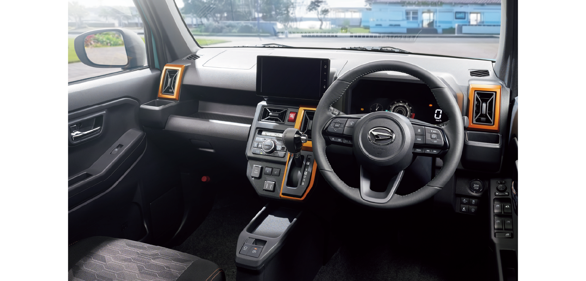 Interior of a modern SUV cockpit featuring a large central touchscreen, digital instrument cluster, and orange-accented vents around the center console and steering wheel grip area.
